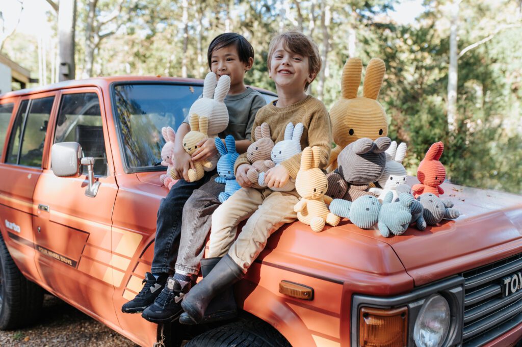 2 boys sitting surrounded by many sustainable plush toys from Bon Ton Toys