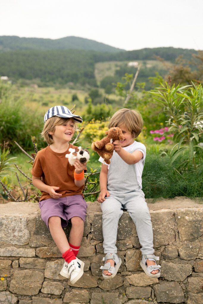 Two boy playing with their sustainable plush toys